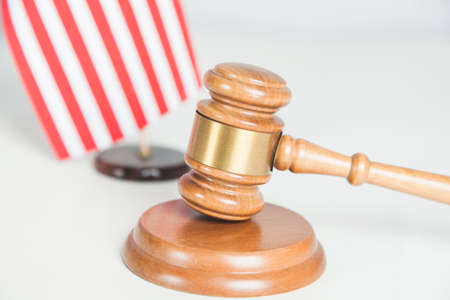 wooden judge and american flag on deskの写真素材