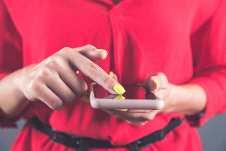 fashion young woman hand holding smart phoneの写真素材
