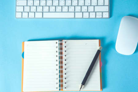 notepad with computer keyboard on the deskの写真素材