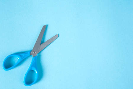 blue scissors on the blue  table backgroundの写真素材