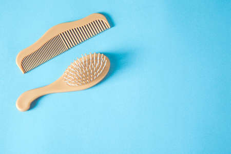 wooden combs on the blue table background