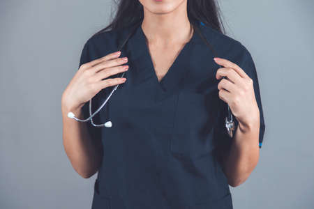 woman doctor hand stethoscope on dark background
