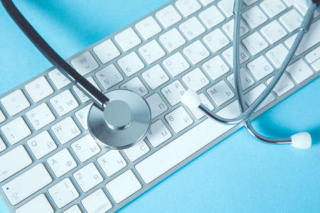 stethoscope on the computer keyboard on deskの写真素材