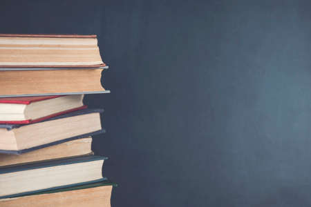 different books on the black chalkboard backgroundの写真素材
