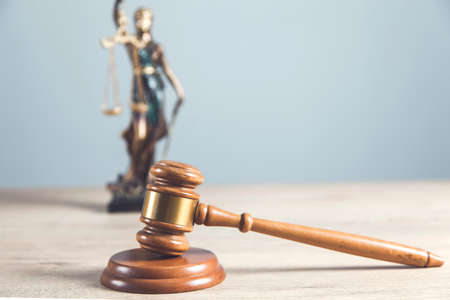 wooden judge with justice lady on gray wall backgroundの写真素材