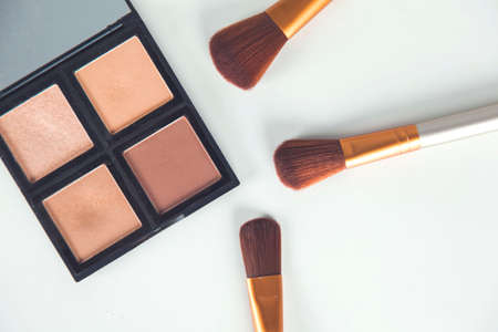 makeup accessories with brushes on the white deskの写真素材
