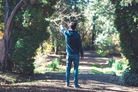young traveler man show in the forest
