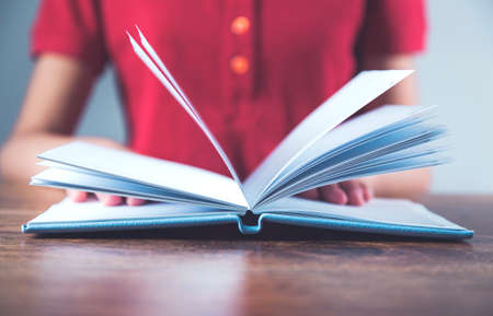 woman hand blue notepad on desk