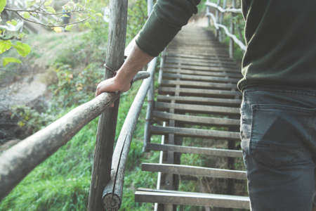man in wooden stair in nature