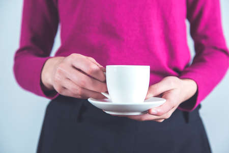 young woman hand holding cup of coffee