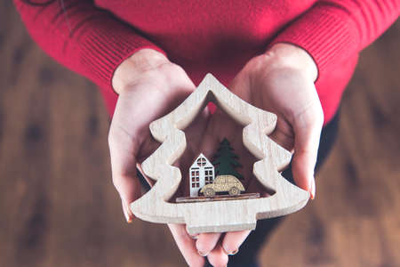 woman hand holding wooden Christmas treeの写真素材