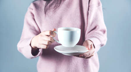 woman hand holding cup of tea or coffee