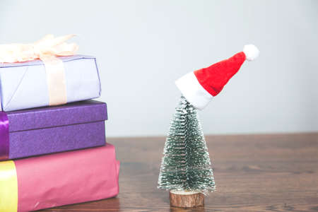 different and colorful gift boxes and Christmas tree on deskの写真素材