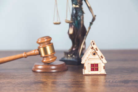 house model with judge and justice lady on desk