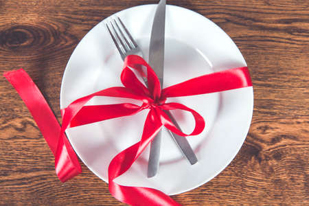 knife and fork in a plate on the deskの写真素材