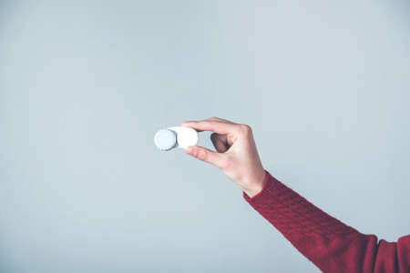 woman hand lenses on the gray background