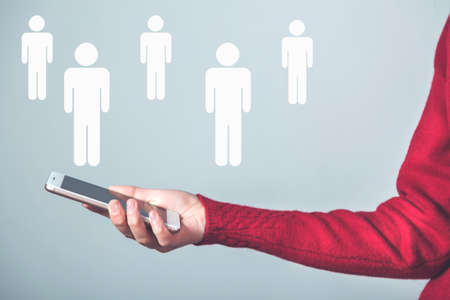 woman hand smart phone with team icon in screenの写真素材