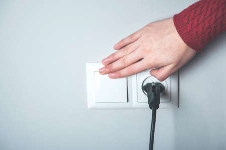 A woman turn on the light in homeの写真素材