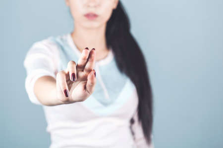 woman touching in screen on gray background