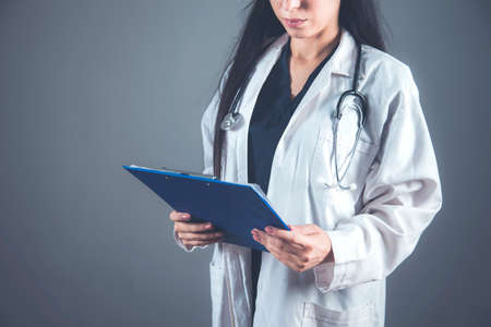 woman doctor hand document on the dark background