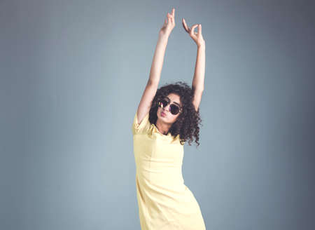 woman hand okay sign in gray wall studio