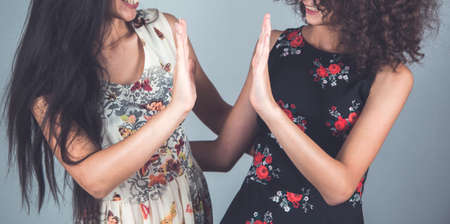 two happy and young woman in studio
