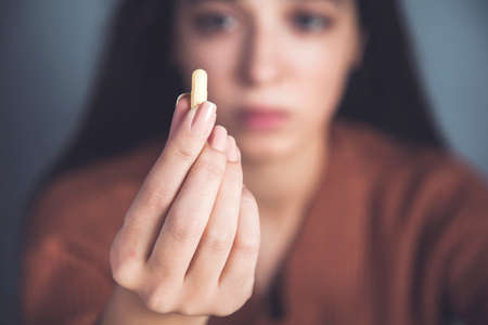 sad woman hand Pills on dark backgroundの写真素材