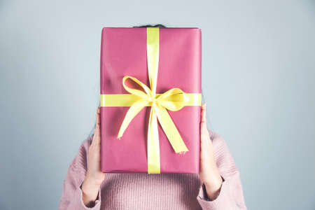woman hand beautiful gift box in face の写真素材
