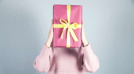 woman hand beautiful gift box in faceの写真素材