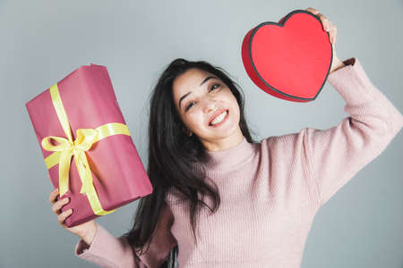 young happy woman hand gift box with heartの写真素材