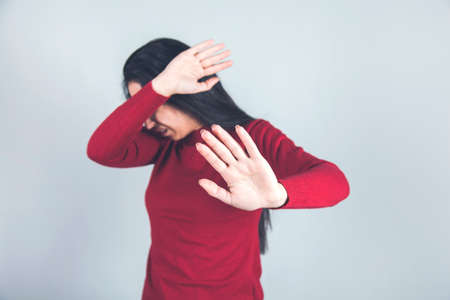 sad woman hand stop sign on gray background