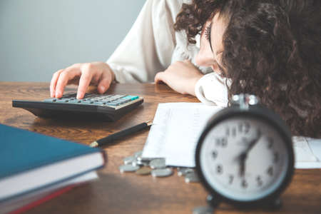 sleeping business woman hand calculator in office deskの写真素材