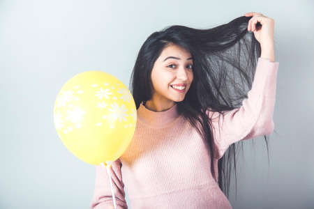 happy woman hand balloon on gray backgroundの写真素材