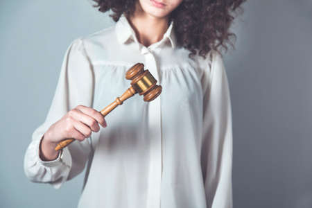 women hand wooden judge on gray backgroundの写真素材