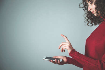 young woman hand smart phone with touching in screenの写真素材
