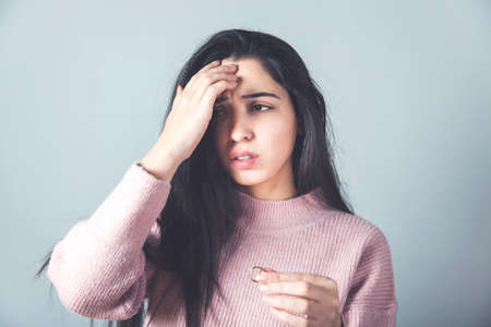 sad woman hand ring on grey background