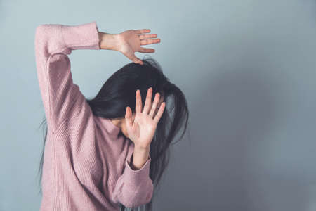 sad woman hand stop sign on grey background