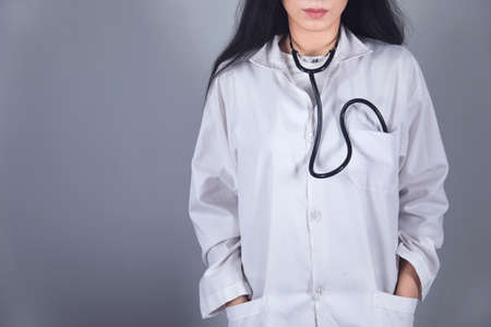 doctor hand on pocket on grey backgroundの写真素材