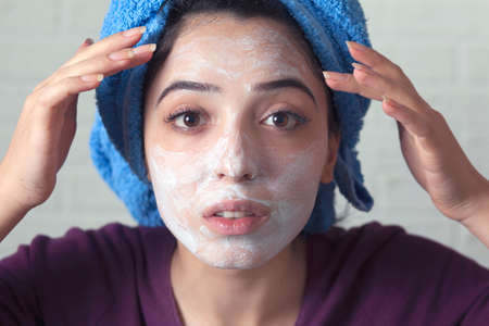 woman face white mask on brick wall background