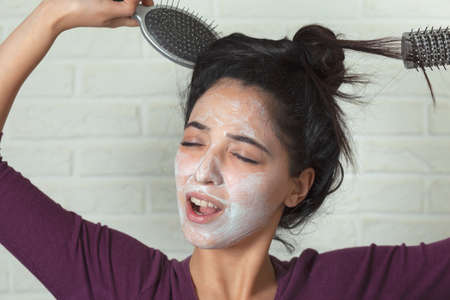 woman face white mask on brick wall backgroundの写真素材