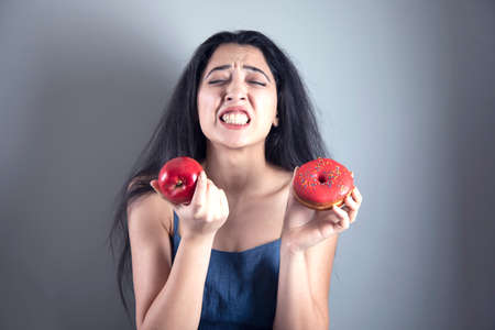 sad woman hand donut and apple