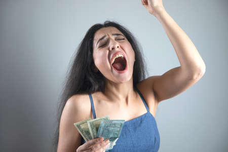 happy young woman hand holding moneyの写真素材