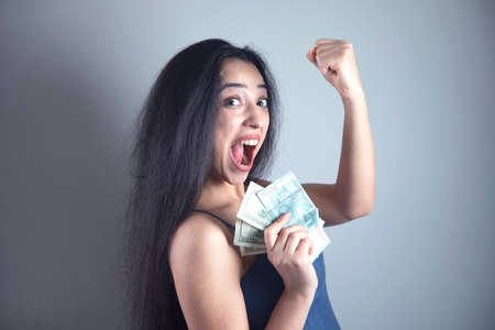 happy young woman hand holding money