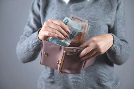 young woman hand money with walletの写真素材