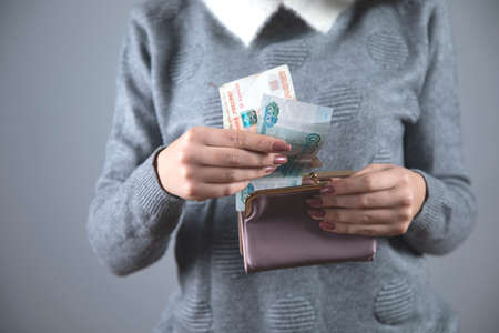 young woman hand money with walletの写真素材