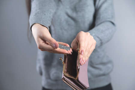 young woman hand holding  coin with walletの写真素材