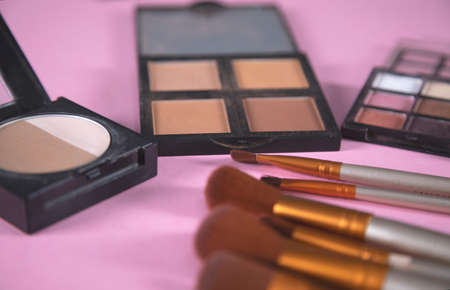 different makeup products and brushes on tableの写真素材