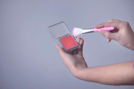woman hand holding makeup brushesの写真素材