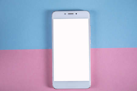white smart phone on the color table backgroundの写真素材