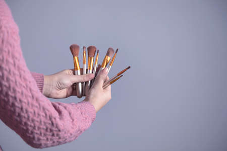 woman hand holding makeup brushesの写真素材